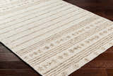 Close-up of the hand woven Matawan Premium Wool Rug in cream with brown stripes on dark wood floors. Corner