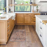 Farmhouse kitchen with wood cabinets and the brick red Lumpkin Area Rug on hardwood floors. Roomscene-Rectangle