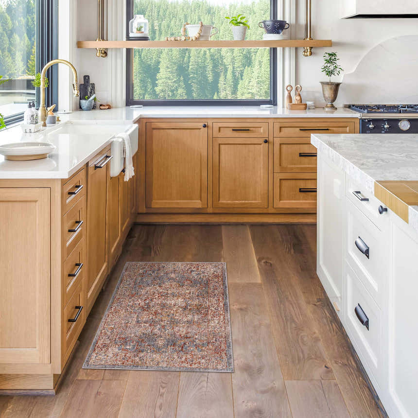 Farmhouse kitchen with wood cabinets and the brick red Lumpkin Area Rug on hardwood floors. Roomscene-Rectangle