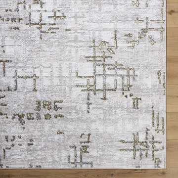 Close-up of the Auriel Gray Area Rug. Features a contemporary charcoal, cream, and gray abstract design. Swatch