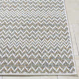 Close-up of the Alazne Ivory Area Rug featuring a white chevron pattern with sage, tan, and taupe hues. Front