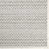 Close-up of Alazne Ivory Area Rug. Farmhouse style rug with a geometric pattern in ivory, sage, tan, and taupe. Corner