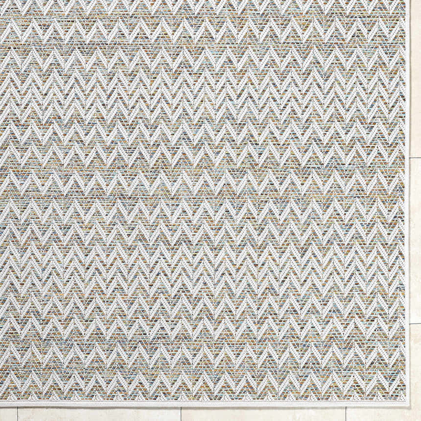 Close-up of Alazne Ivory Area Rug. Farmhouse style rug with a geometric pattern in ivory, sage, tan, and taupe. Corner