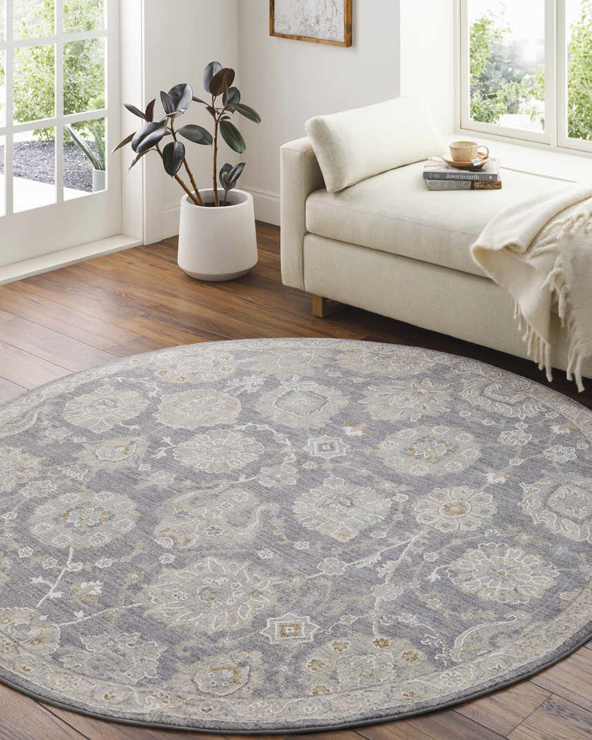 Bright living room with a round Mimarsinan rug in gray floral pattern, beige chaise lounge, and potted plant. Roomscene-Round