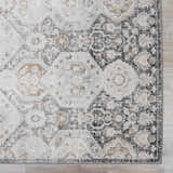 Close-up of the Minoa Area Rug featuring a beige, black, and gray bohemian pattern. Machine woven texture detail. Swatch