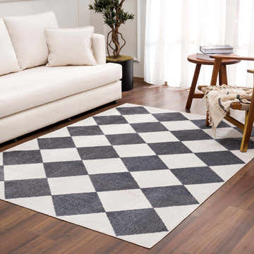 Living room scene with cream sofa and Ulric Navy Blue Diamond Washable Area Rug. Roomscene-Rectangle