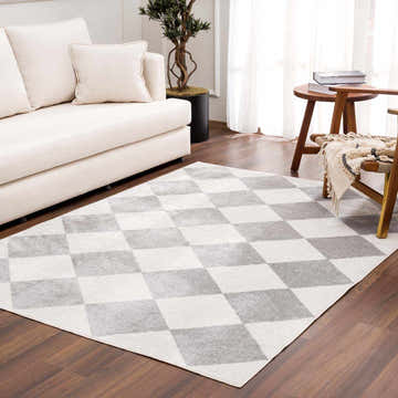 Living room scene with cream sofa and Ulric Light Gray Diamond Washable Area Rug on dark wood floor. Roomscene-Rectangle