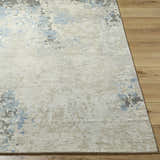 Close up of the Marco Handmade Wool Rug, showing charcoal, cream, denim and light beige abstract pattern and wool texture. Front