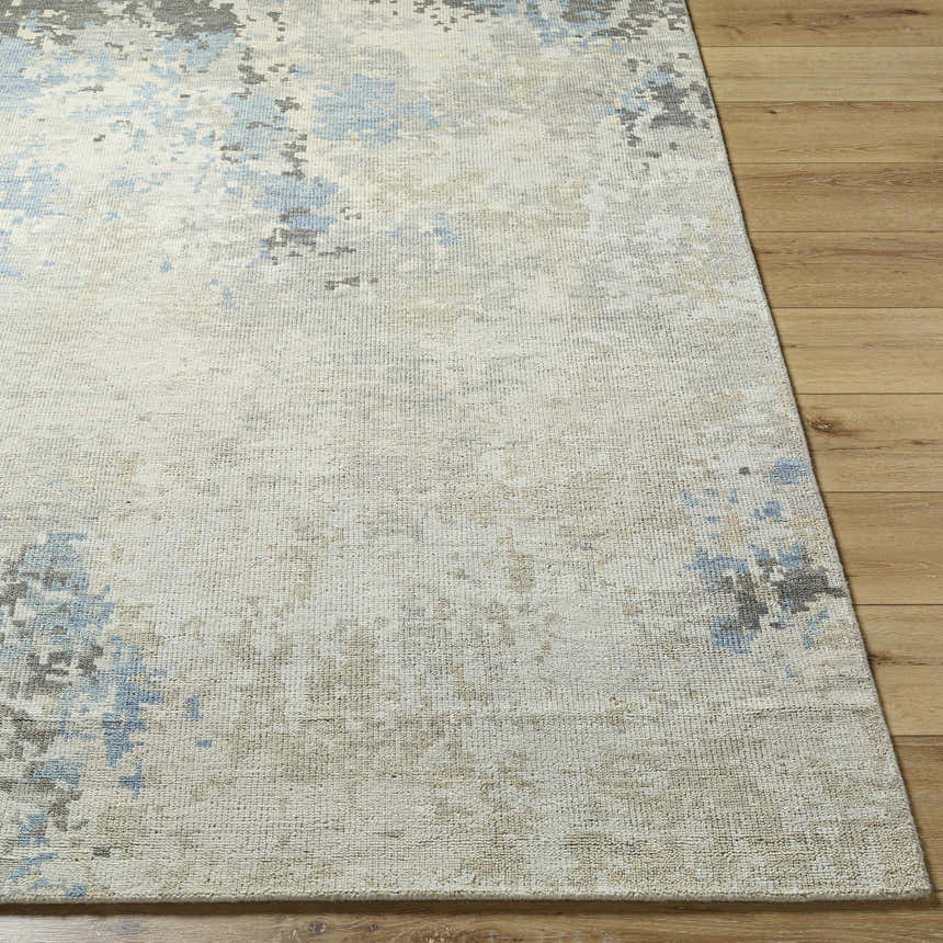 Close up of the Marco Handmade Wool Rug, showing charcoal, cream, denim and light beige abstract pattern and wool texture. Front