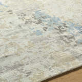 Close up of the hand knotted Marco Handmade Wool Rug with charcoal, cream, denim and gray abstract pattern. Texture