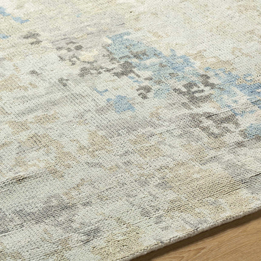 Close up of the hand knotted Marco Handmade Wool Rug with charcoal, cream, denim and gray abstract pattern. Texture