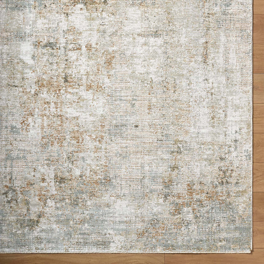Close-up of the Marli Thick Luxe Area Rug. Abstract design with charcoal, cream, light brown, and light gray tones. Corner