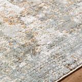 Close-up of the Marli Thick Luxe Area Rug showing its charcoal, cream, and light brown abstract pattern and plush texture. Texture