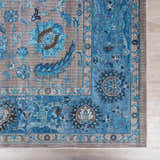 Close up of the Mardina Turquoise Area Rug showing its traditional floral pattern and blue and beige colors. Swatch