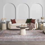 Living room scene with a blush and gray Moora Washable Area Rug under a sofa and round coffee table. Roomscene-Rectangle