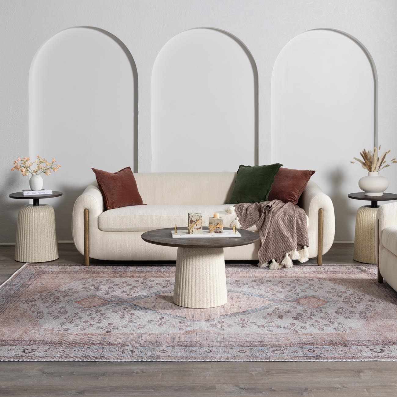 Living room scene with a blush and gray Moora Washable Area Rug under a sofa and round coffee table. Roomscene-Rectangle