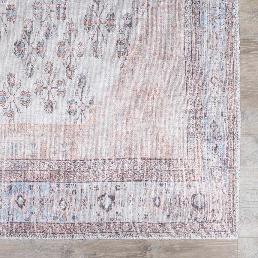 Close-up of the Moora Washable Area Rug; oriental design in aqua, blush, and brown tones. Machine-woven texture. Swatch