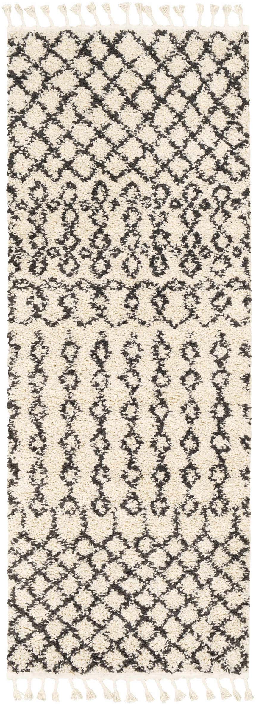 Close-up of the Muni Berber Shag Rug. Charcoal and light beige diamond pattern with tassels. Bohemian style. Design-Runner-2773