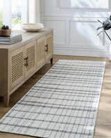 Entryway with a Nissa Ivory runner rug, light wood console table, and white walls. Roomscene-Runner