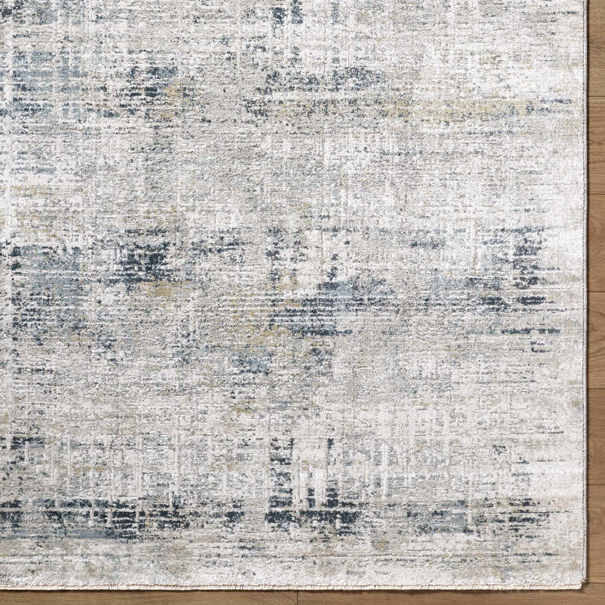 Close-up of Neron Thick Luxe Abstract Rug. Southwestern style rug in blue, charcoal, cream, and mustard. Corner