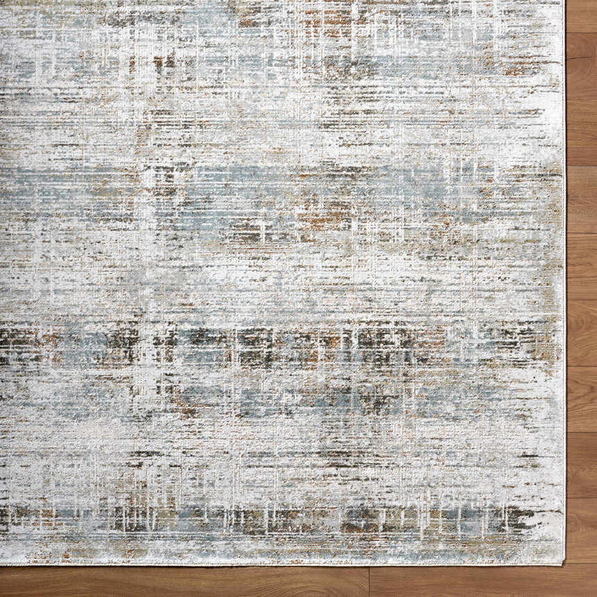 Close-up of the Neron Blue Gray Rug. Abstract design with charcoal, cream, brown, and blue gray hues. Luxe texture. Corner