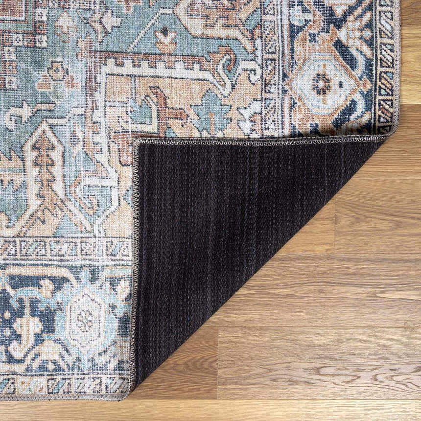Close-up of the Green Nisa Tumble Dry Washable Rug showing its oriental-style design, seafoam, tan, and navy colors. Fold