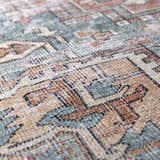 Close-up of the Green Nisa Tumble Dry Washable Rug, showcasing its seafoam, tan, and brick red Persian-style pattern and texture. Texture
