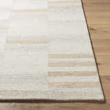 Close-up of the hand-tufted Max Handmade Becki Owens x LIVABLISS BOMX-2300 Area Rug. Cream and tan wool texture. Front