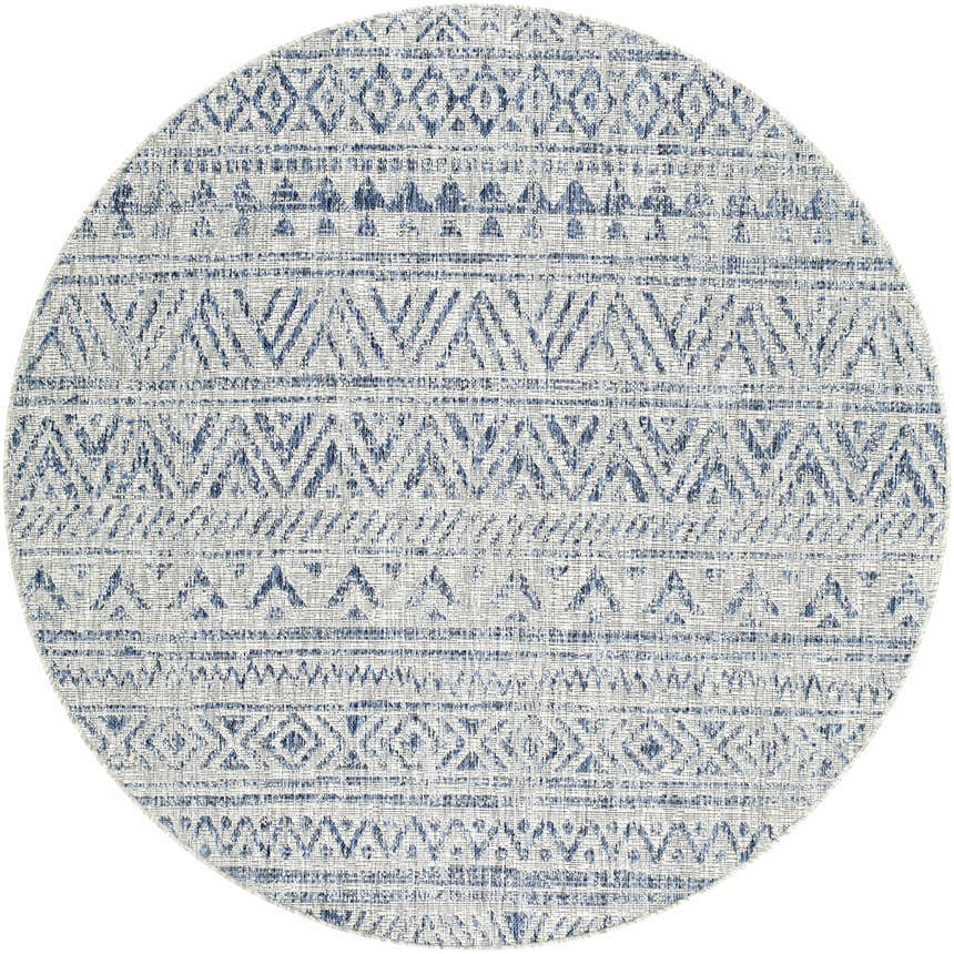 Close-up of the round Novato All Over Pattern Performance Rug. Features a blue geometric design on a textured light background. Design-Round-53