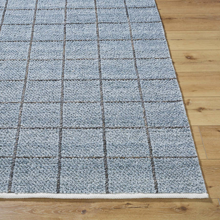 Close up of the hand woven Ayinde Area Rug. Slate blue recycled yarn with a contemporary grid pattern. Front