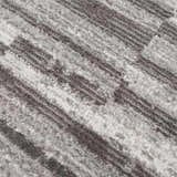 Close-up of the Arissa Broken-Striped Area Rug. Gray, white, and black geometric pattern. Soft, textured polyester. Texture