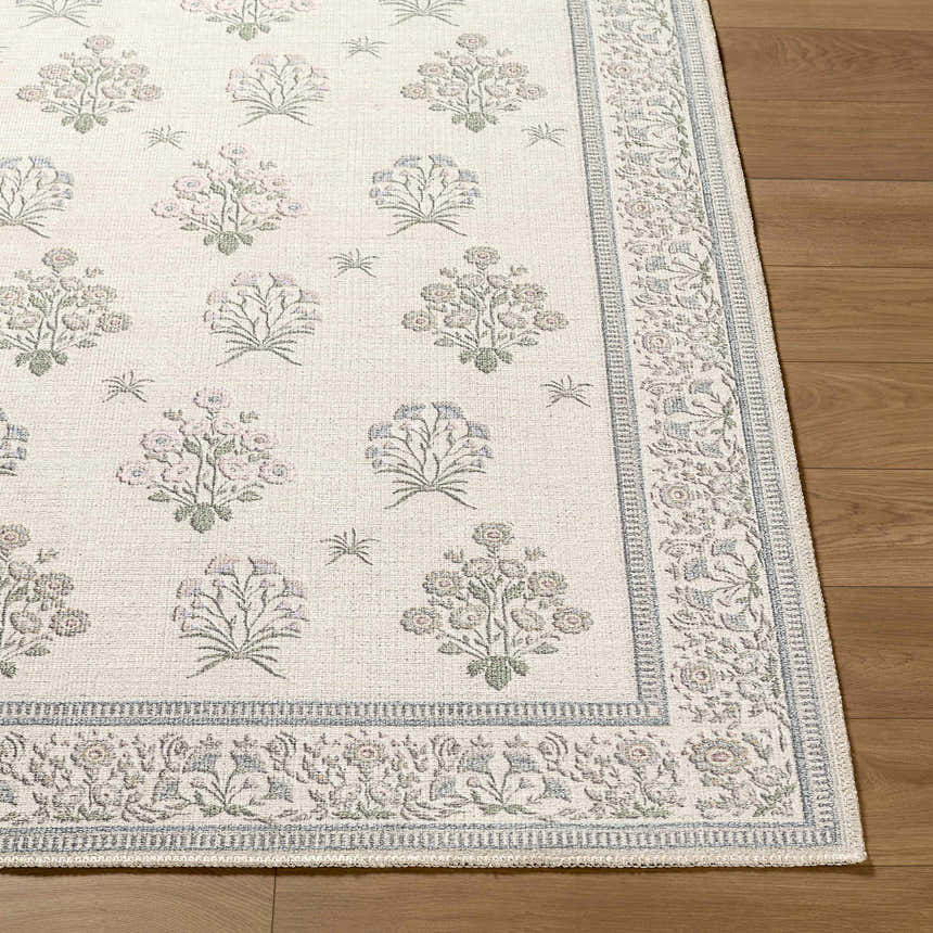 Close-up of Aquene Ivory Washable Area Rug showing floral pattern in blush, sage, sky blue, and taupe on a textured ivory background. Front