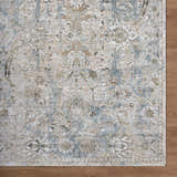 Close-up of the Nasir Thick Luxe Boutique Rug. Features charcoal, cream, light brown, and light gray floral pattern. Corner