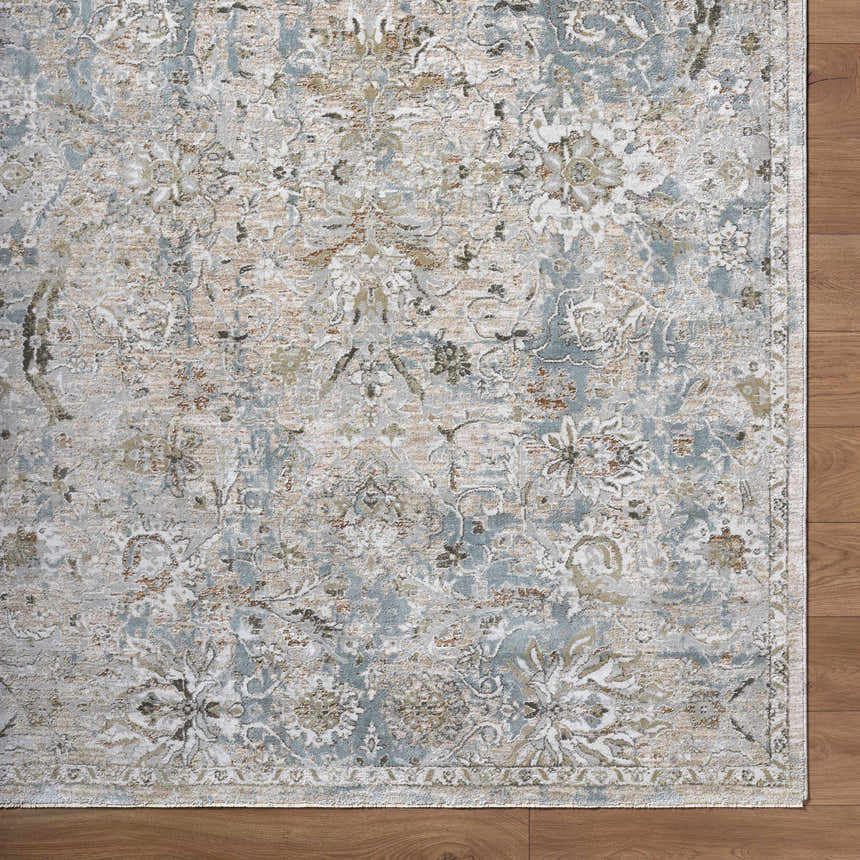 Close-up of the Nasir Thick Luxe Boutique Rug. Features charcoal, cream, light brown, and light gray floral pattern. Corner