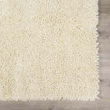 Close-up of a cream Oakridge Area Rug showing its hand woven, textured wool design. Swatch
