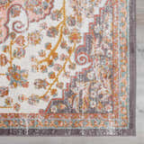 Close-up of the Oark Floral Medallion Area Rug. Features brick red, camel, and dusty pink floral pattern on off-white. Swatch