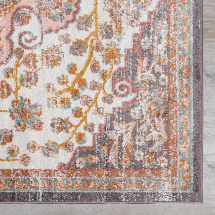 Close-up of the Oark Floral Medallion Area Rug. Features brick red, camel, and dusty pink floral pattern on off-white. Swatch