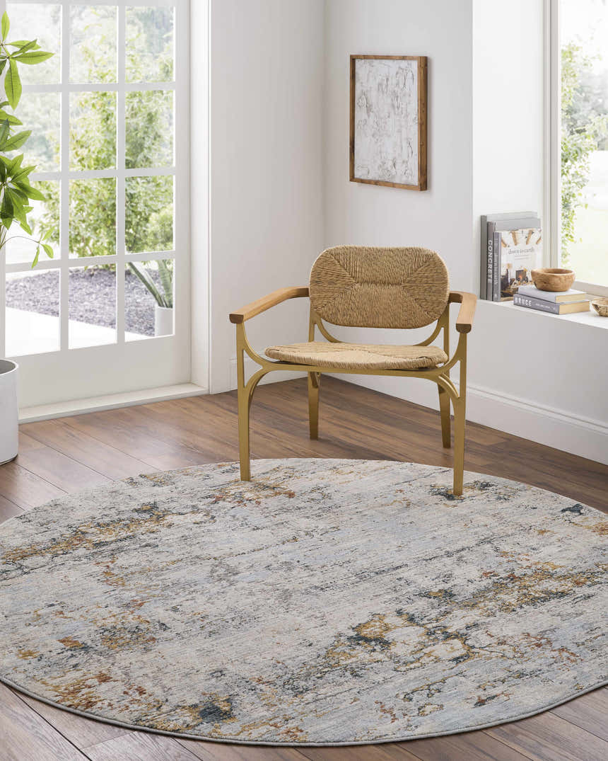 Bright room with a round Ottawa Luxe Rug, light wood floors, and woven chair. Roomscene-Round