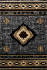 Close-up of the Buckhaven Area Rug. Southwestern design in black, charcoal, beige, and brown. Polypropylene, machine woven texture. Design-Rectangle