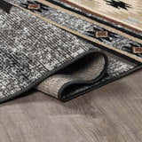 Close-up of the Buckhaven Area Rug showing its Southwestern pattern, colors, texture, and machine-woven construction. Fold