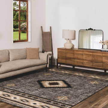 Living room scene with a brown Buckhaven Area Rug, beige sofa, and wooden furniture. Roomscene-Rectangle