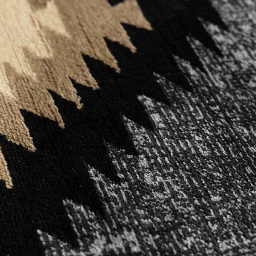 Close-up of the Buckhaven Area Rug showing a black, tan, and gray Southwestern-style geometric pattern. Texture