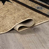 Close-up of the Buckhaven Brown Aztec Carpet showing its beige, brown, and black geometric pattern and soft, textured pile. Fold