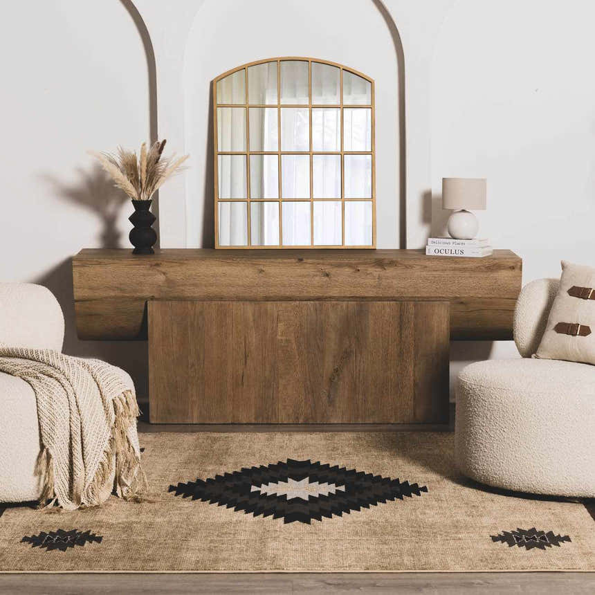 Living room scene with a Buckhaven Brown Aztec Carpet, beige chairs, and a wood console table. Roomscene-Rectangle