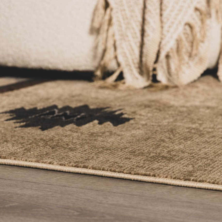 Close-up of the Buckhaven Brown Aztec Carpet showing the texture and pattern details. Tan, black, and brown colors. Styleshot
