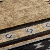 Close-up of the Buckhaven Brown Aztec Carpet showing its tan, black, gray, and brown geometric pattern and soft texture. Texture