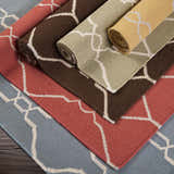 Rolled Partington Brown Wool Carpet Area Rugs in dark brown, beige, peach, and blue with geometric pattern. Styleshot