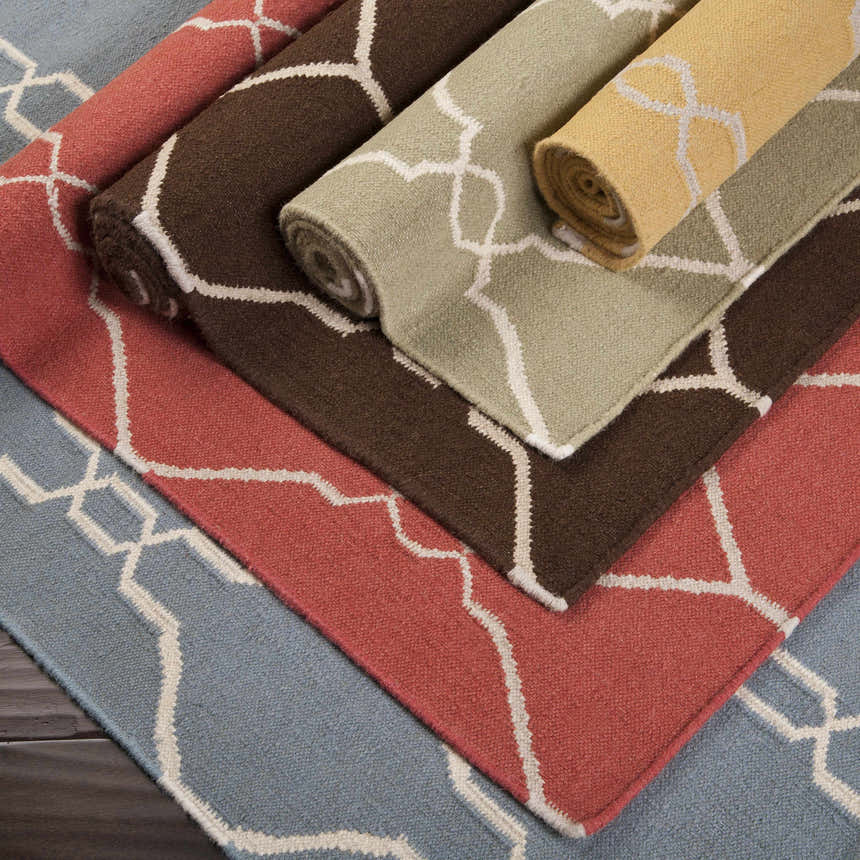 Rolled Partington Brown Wool Carpet Area Rugs in dark brown, beige, peach, and blue with geometric pattern. Styleshot
