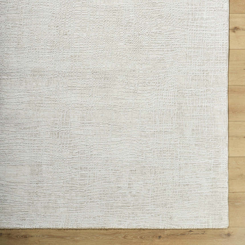 Close-up of the Axelia Charcoal Area Rug, showing its subtle cream and charcoal grid-like pattern and soft texture. Corner
