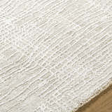 Close-up of the Axelia Charcoal Area Rug showing its cream and charcoal Southwestern-inspired geometric pattern. Texture